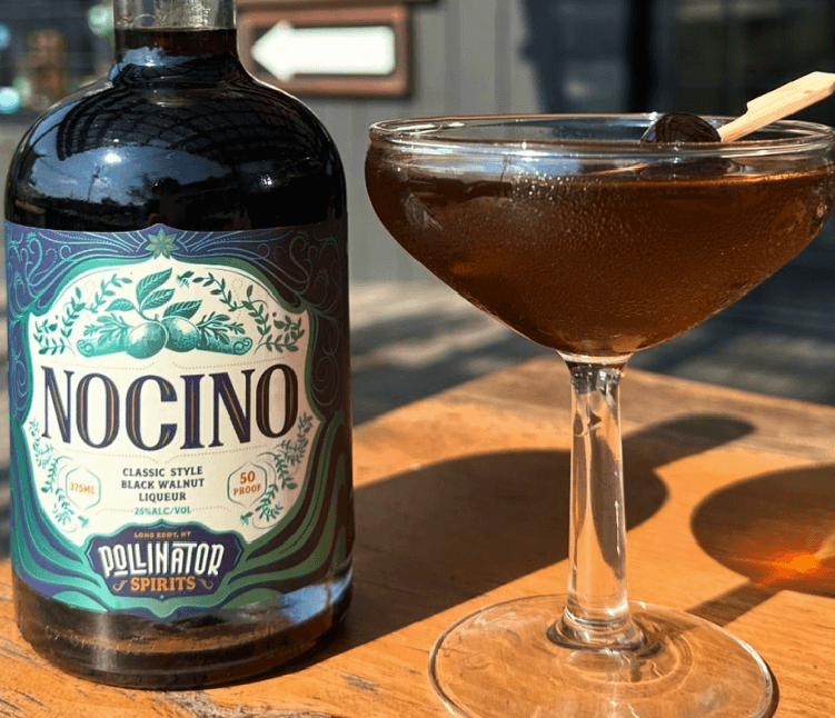 Rich walnut liqueur served with a dark, aromatic cocktail