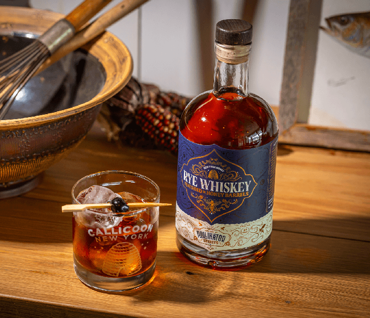 Pollinator Rye Whiskey bottle with rye whiskey cocktail. Smooth and spicy spirit