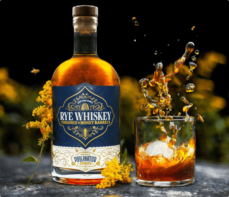 Glass of whiskey cocktail beside Pollinator Rye Whiskey bottle made in the Catskills