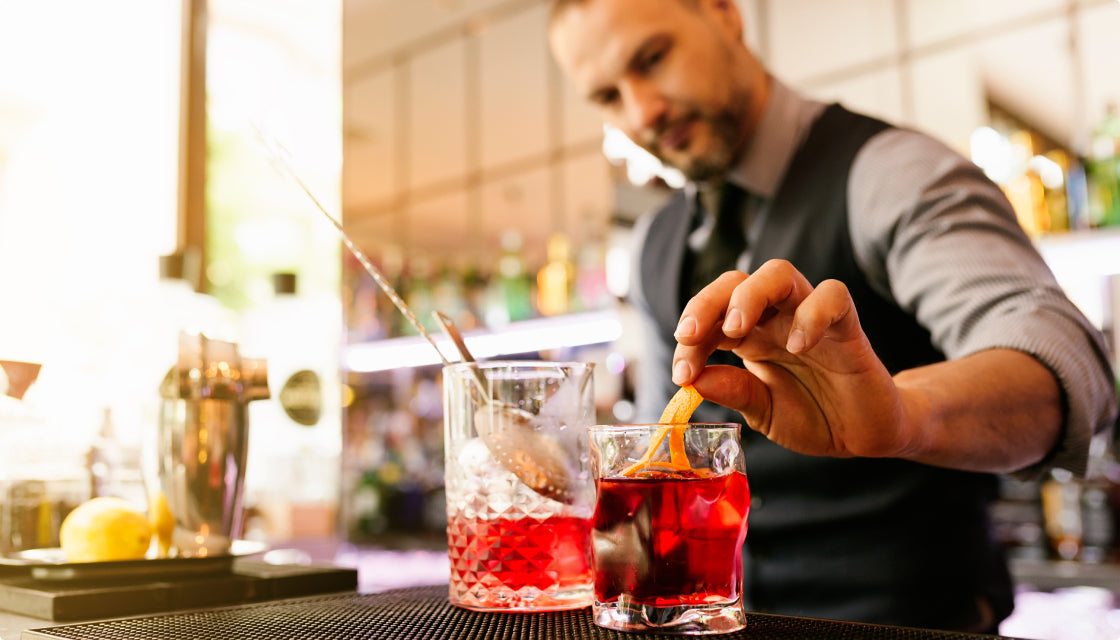 Eco-friendly home bar setup with reusable cocktail tools and fresh citrus garnishes