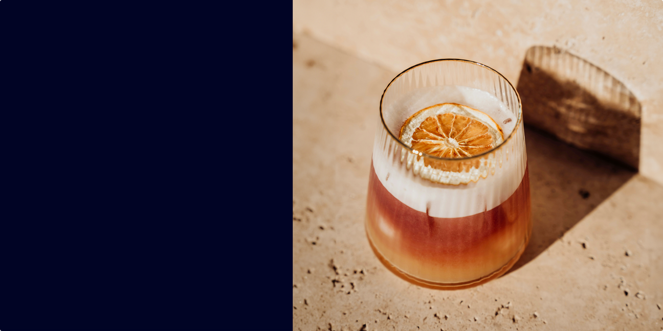 Golden Hour Sour cocktail made with Pollinator Crimson Amaro, served in a coupe glass with lemon garnish