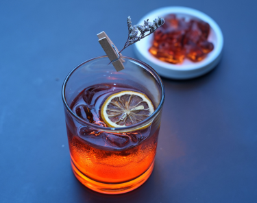 Glass of Bonfire Cider cocktail made with Bonfire Rye whiskey, apple cider, and cinnamon garnish